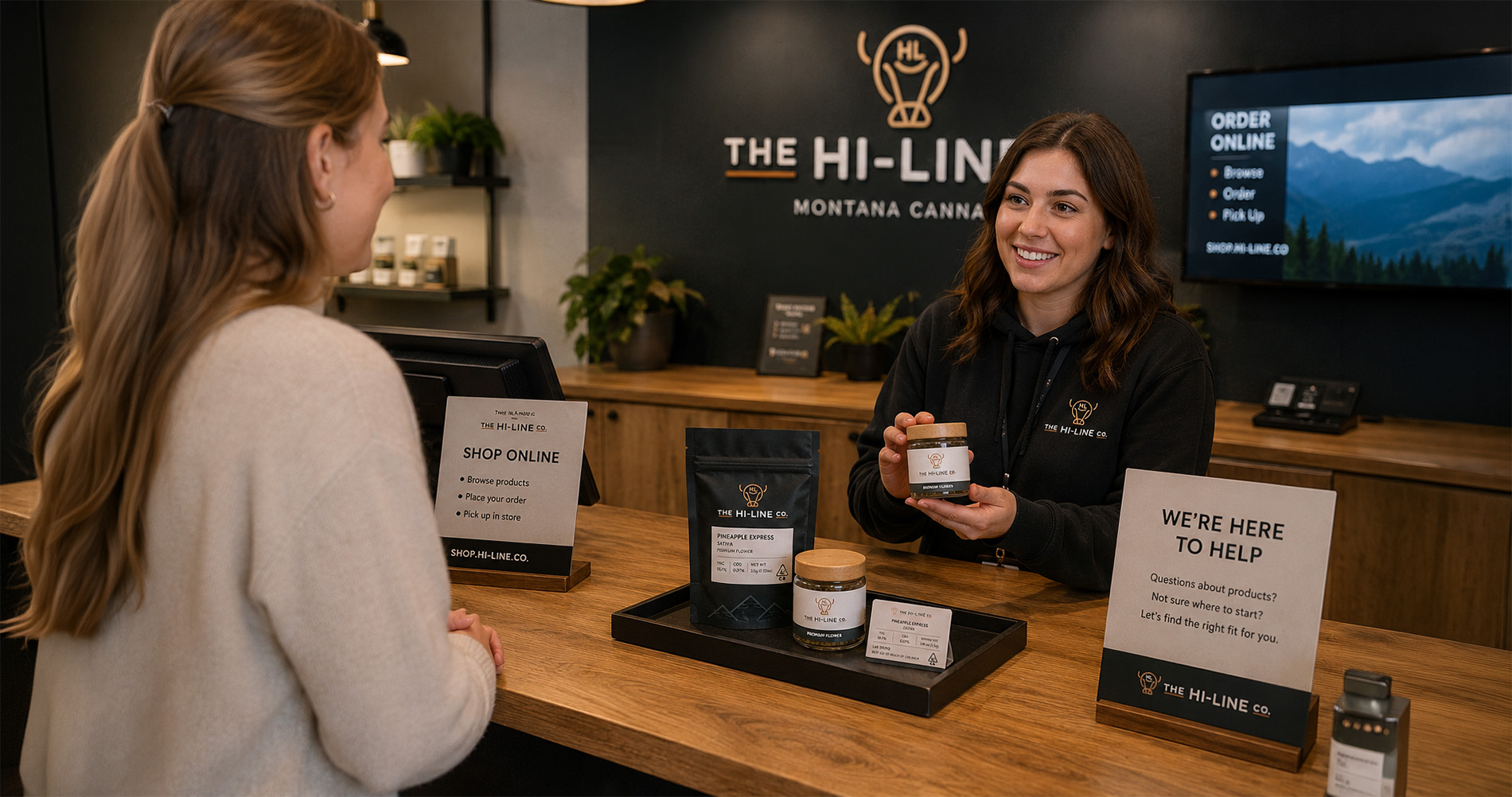 Hi‑Line Co employee assisting a customer at the counter with cannabis products and informational signage.